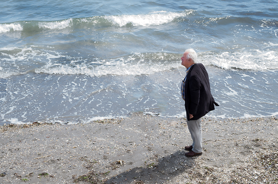 Old man staring at the sea size